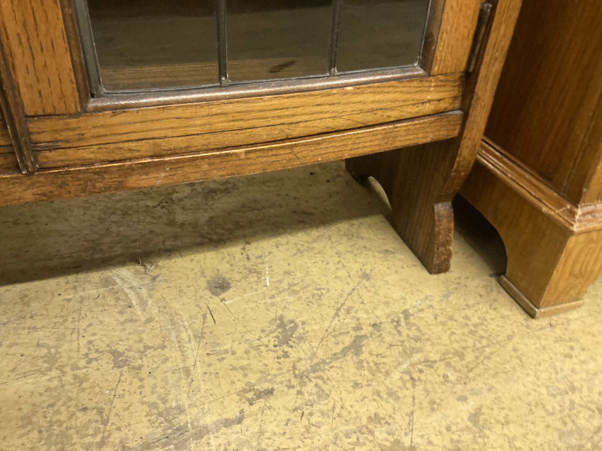 A 1920s oak bow front bookcase, length 73cm, width 26cm, height 110cm